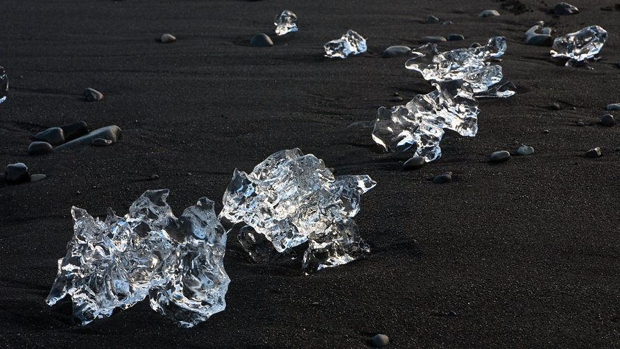 ice diamands on black beach