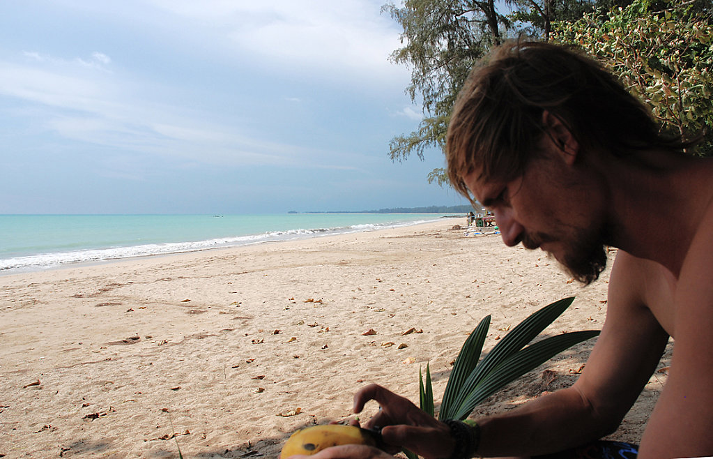 Mark peeling mangos at the beach